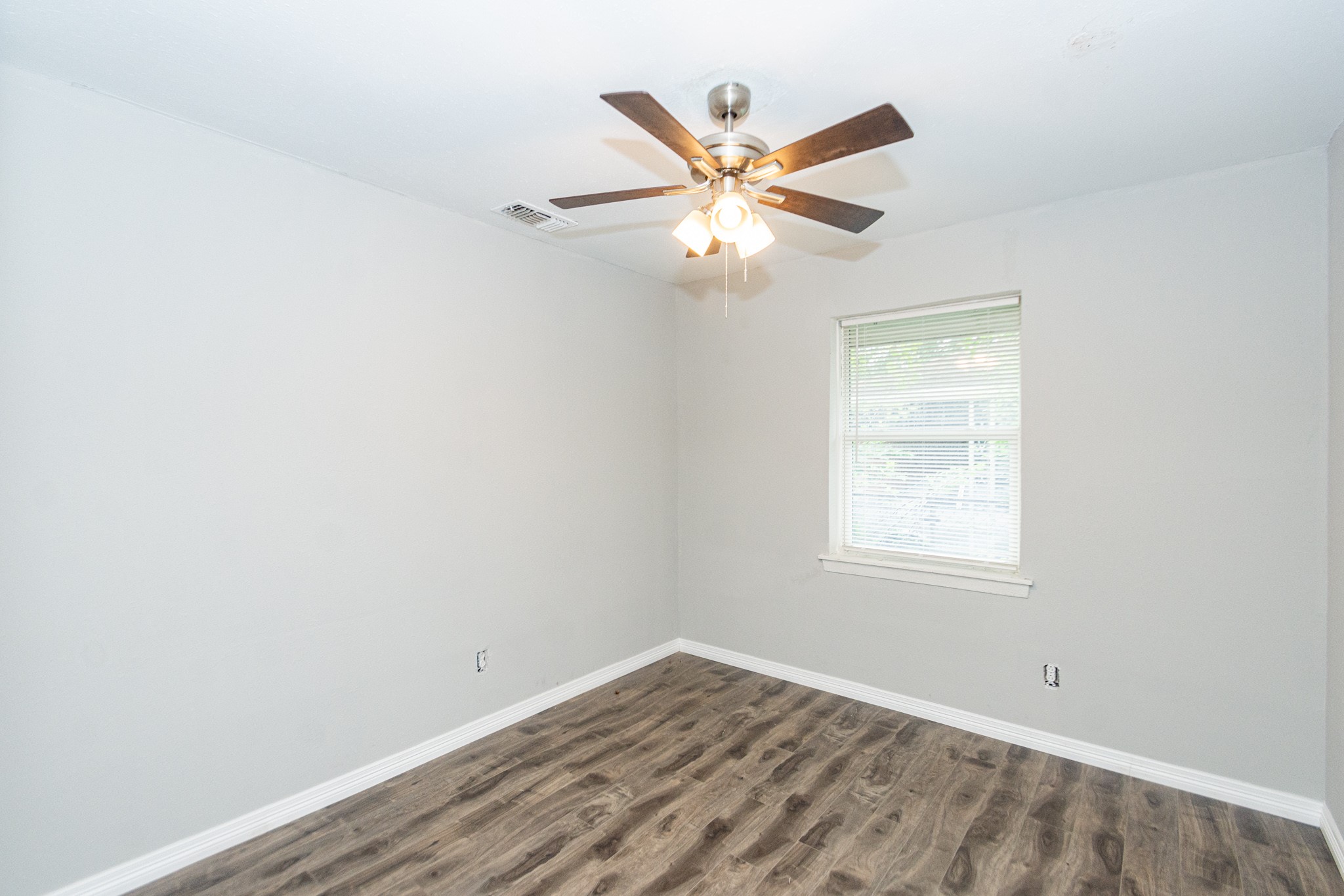 2002 Nottingham Street Pasadena, TX 77502 - Photo 12 of 33 an empty room with windows and fan