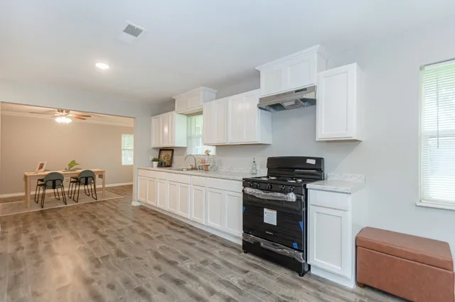 a kitchen with stainless steel appliances granite countertop a stove and a refrigerator