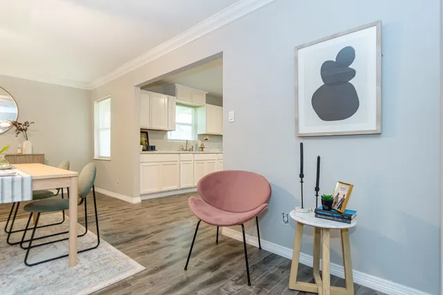 a view of a kitchen area with furniture and wooden floor