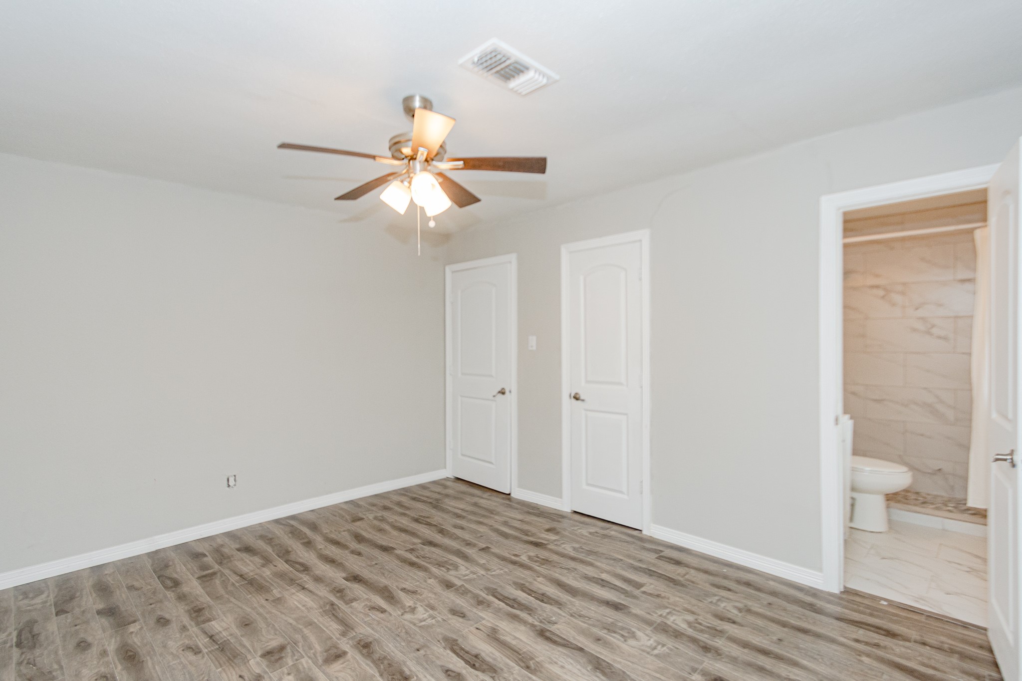 2002 Nottingham Street Pasadena, TX 77502 - Photo 25 of 33 a view of a room with wooden floor and a ceiling fan
