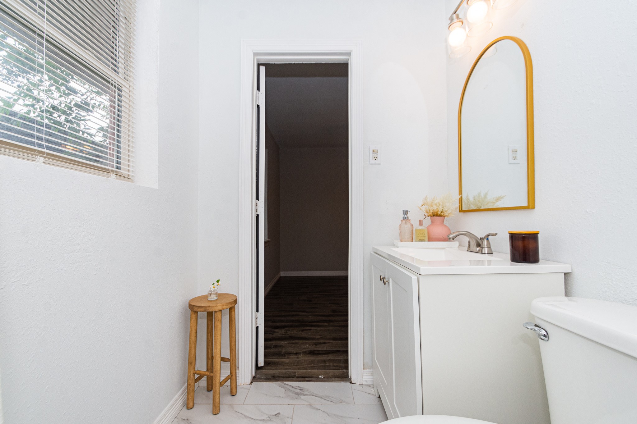 2002 Nottingham Street Pasadena, TX 77502 - Photo 27 of 33 a bathroom with a sink a toilet and a mirror