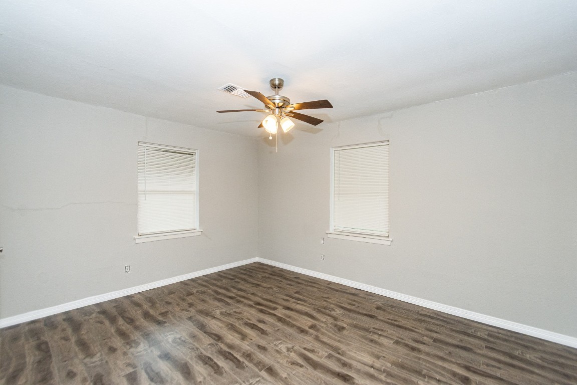 2002 Nottingham Street Pasadena, TX 77502 - Photo 10 of 33 an empty room with wooden floor and ceiling fan