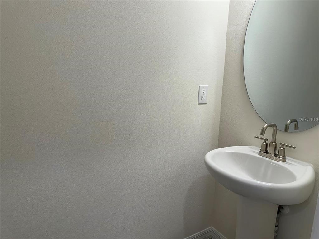 4561 Small Creek Road Kissimmee, FL 34744 - Photo 13 of 32 a bathroom with a sink and a mirror