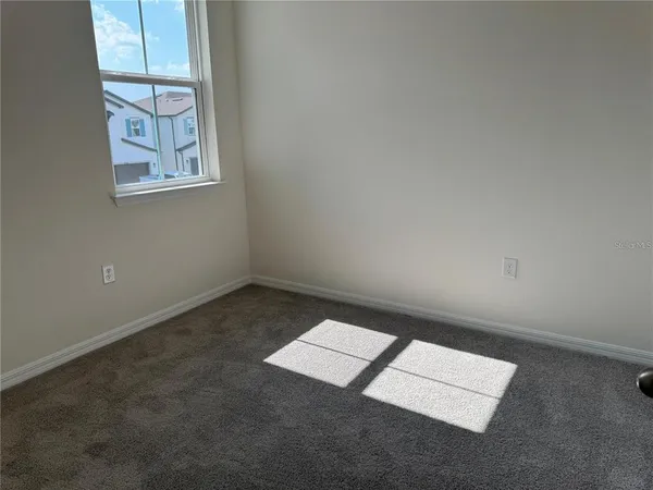 an empty room with windows and closet