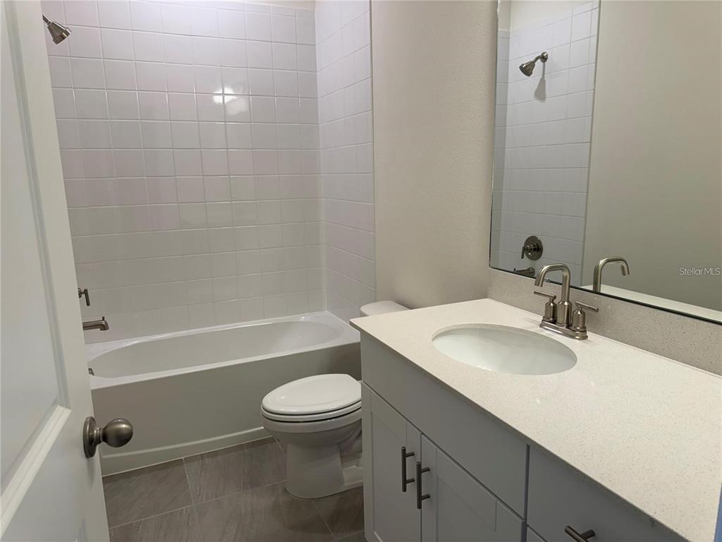 4561 Small Creek Road Kissimmee, FL 34744 - Photo 18 of 32 a bathroom with a sink a toilet and shower