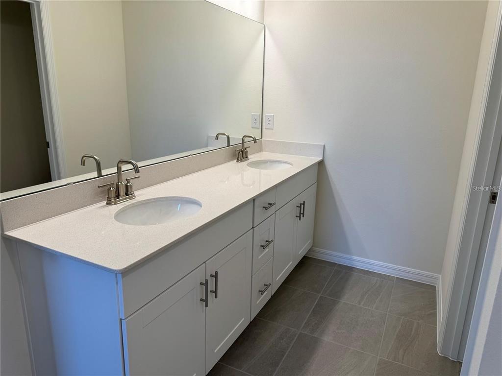 4561 Small Creek Road Kissimmee, FL 34744 - Photo 21 of 32 a bathroom with a sink and a mirror