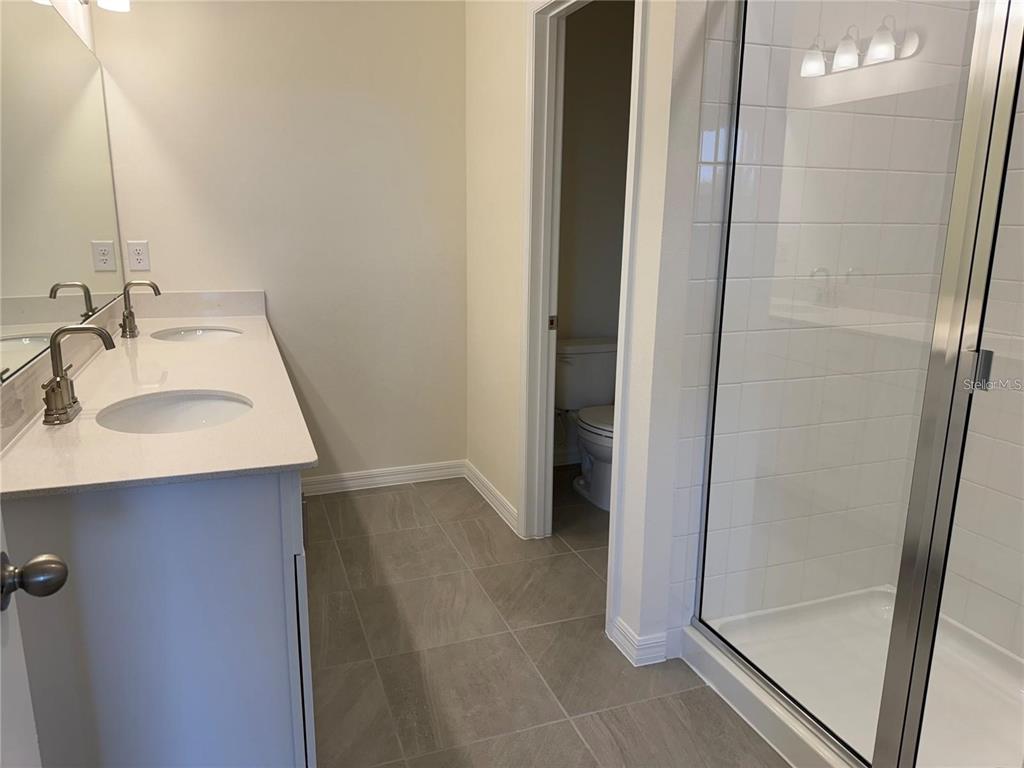 4561 Small Creek Road Kissimmee, FL 34744 - Photo 22 of 32 a bathroom with a sink and a mirror