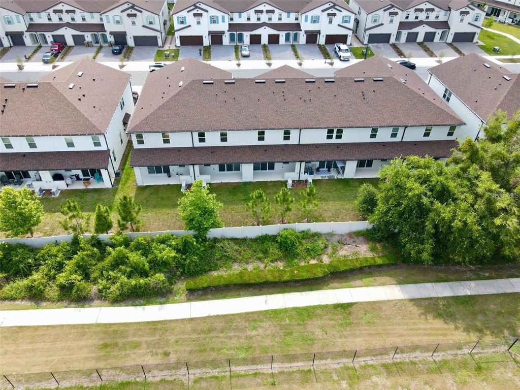 4561 Small Creek Road Kissimmee, FL 34744 - Photo 3 of 32 an aerial view of residential houses with yard and lake view