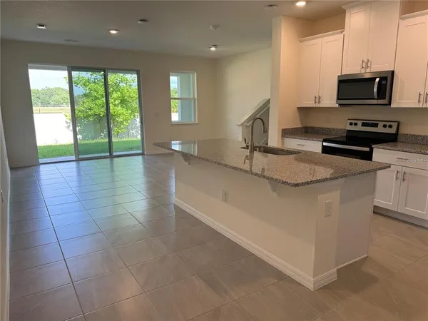 a kitchen with stainless steel appliances granite countertop a sink and a stove