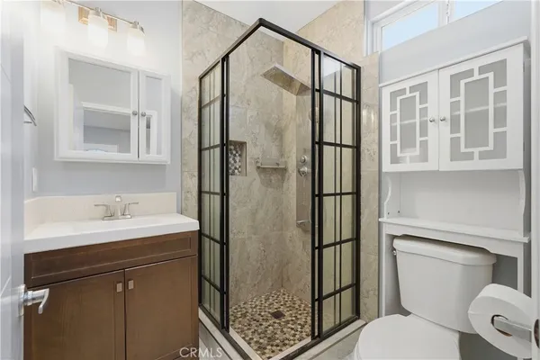 a bathroom with a toilet sink and shower
