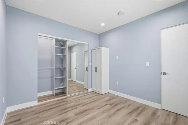 a kitchen with stainless steel appliances granite countertop a refrigerator a stove a sink dishwasher and a refrigerator with wooden floor