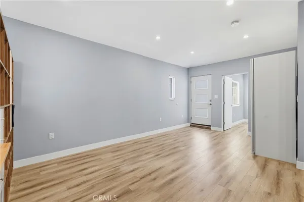 a view of wooden floor and windows in a room