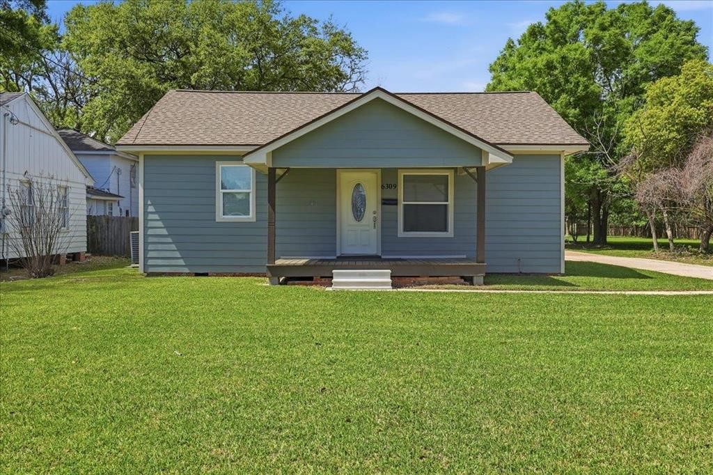 6309 32nd Street Groves, TX 77619 - Photo 1 of 34 a front view of a house with a yard