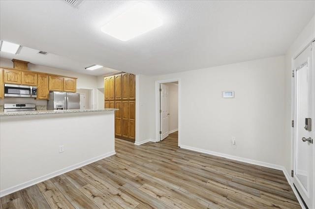 6309 32nd Street Groves, TX 77619 - Photo 12 of 34 a view of kitchen with wooden floor