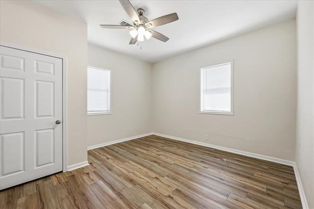 6309 32nd Street Groves, TX 77619 - Photo 13 of 34 wooden floor in an empty room with a window
