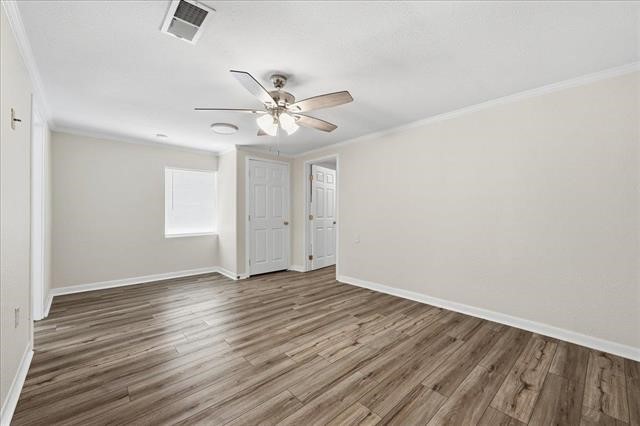 6309 32nd Street Groves, TX 77619 - Photo 14 of 34 a view of an empty room with wooden floor