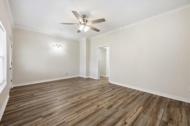 6309 32nd Street Groves, TX 77619 - Photo 15 of 34 an empty room with wooden floor fan and windows