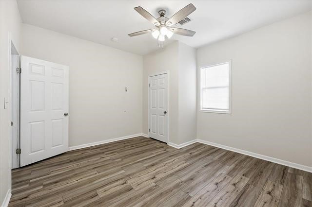 6309 32nd Street Groves, TX 77619 - Photo 20 of 34 wooden floor in an empty room with a window