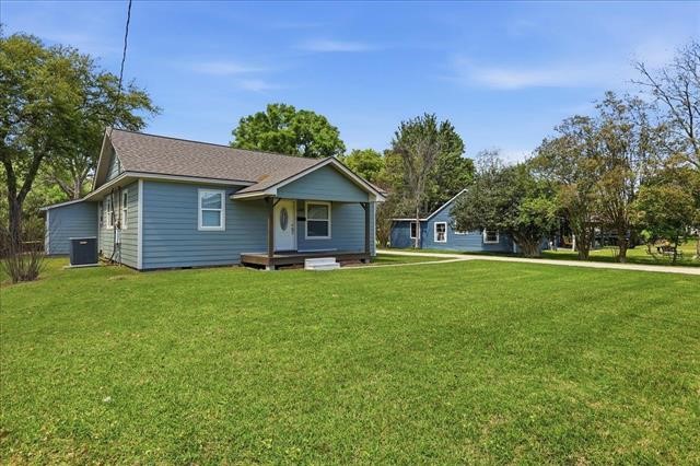 6309 32nd Street Groves, TX 77619 - Photo 2 of 34 a front view of a house with a garden