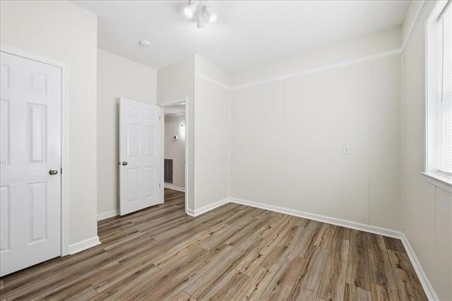 6309 32nd Street Groves, TX 77619 - Photo 21 of 34 a view of an empty room with wooden floor