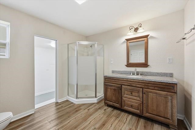 6309 32nd Street Groves, TX 77619 - Photo 27 of 34 a bathroom with a toilet a sink and mirror