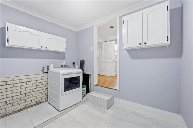 6309 32nd Street Groves, TX 77619 - Photo 29 of 34 a kitchen with granite countertop white cabinets and white appliances