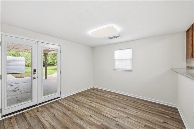 6309 32nd Street Groves, TX 77619 - Photo 31 of 34 an empty room with wooden floor and windows
