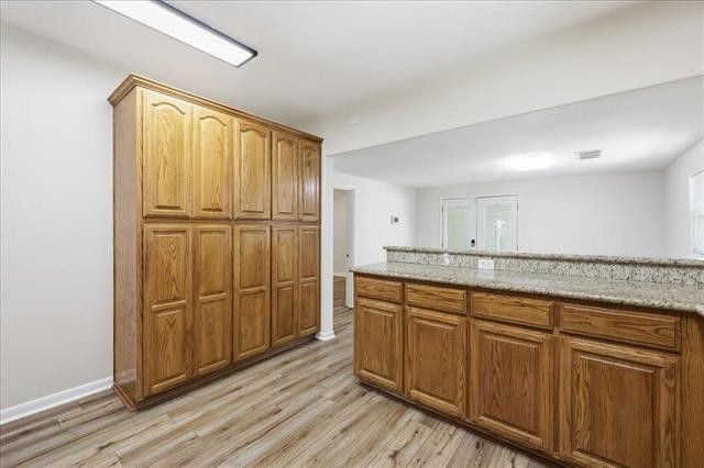 6309 32nd Street Groves, TX 77619 - Photo 10 of 34 a bathroom with a granite countertop sink and a mirror