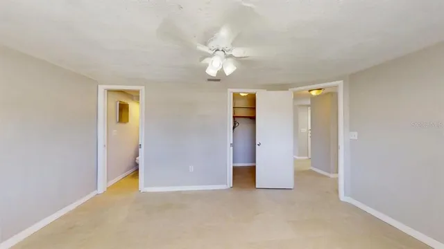 a view of an empty room with a ceiling fan