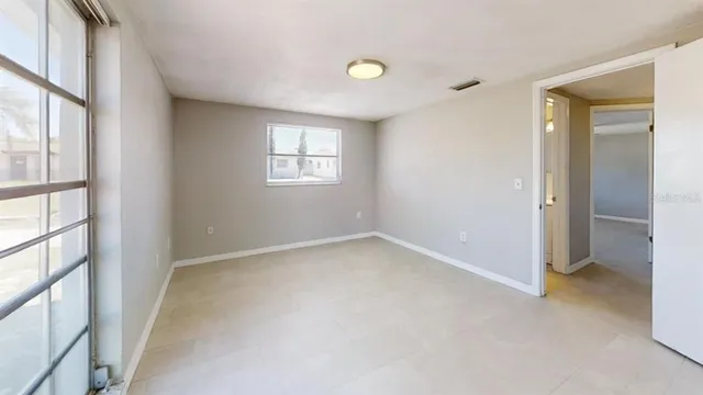 an empty room with windows and closet