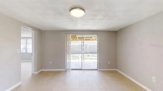an empty room with windows and entrance