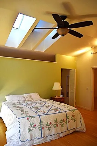 a bedroom with a bed and a painting on the wall