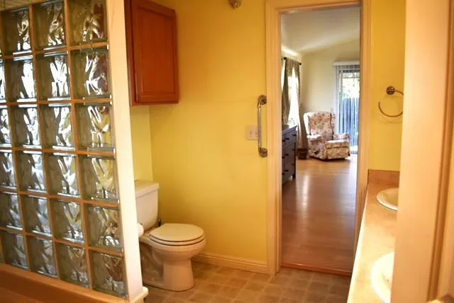 a bathroom with a toilet and a shower