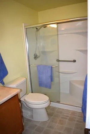 a bathroom with a toilet and a shower