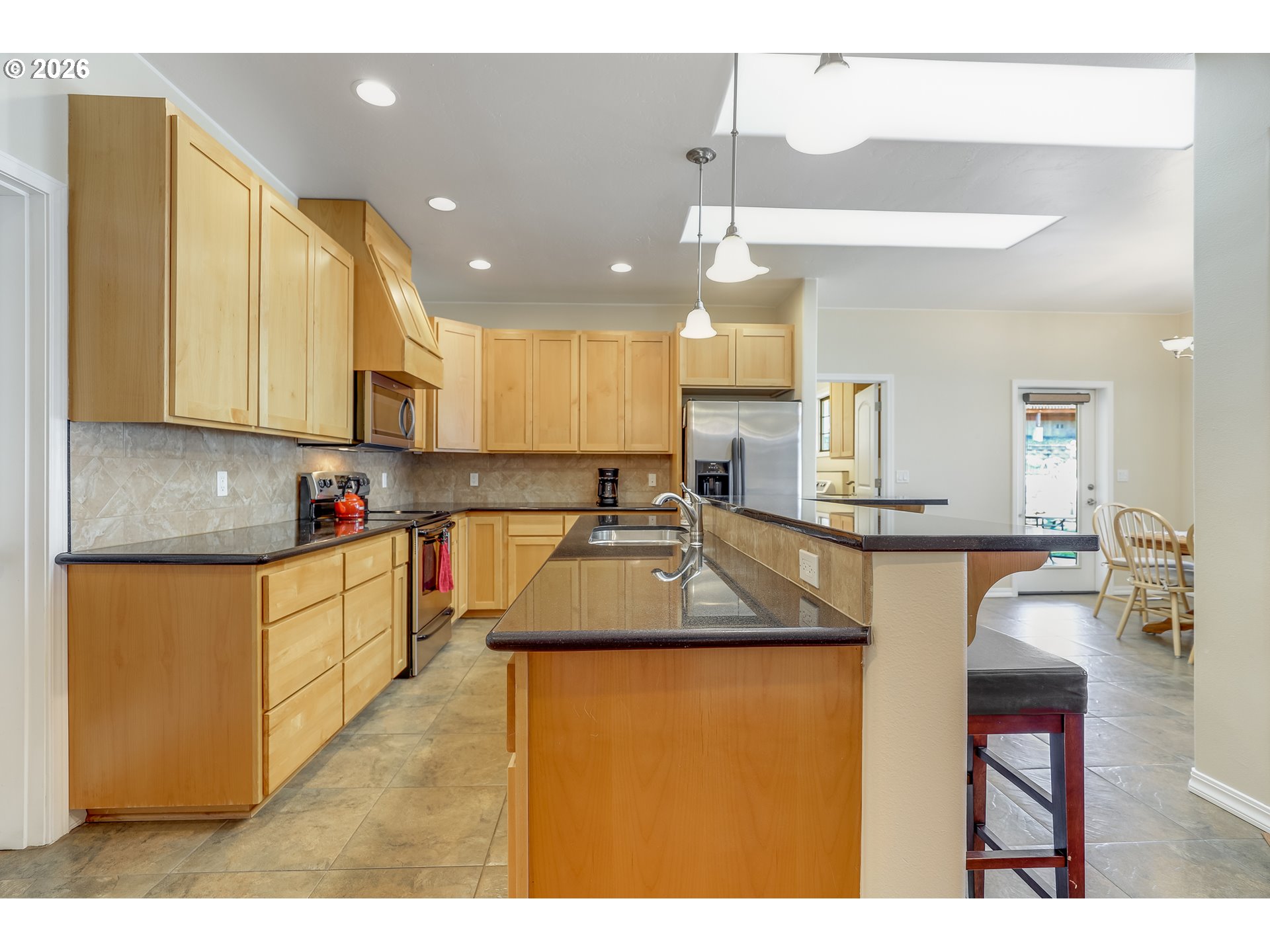 1901 Golden Way The Dalles, OR 97058 - Photo 14 of 48 a kitchen with kitchen island granite countertop a sink counter top space and cabinets