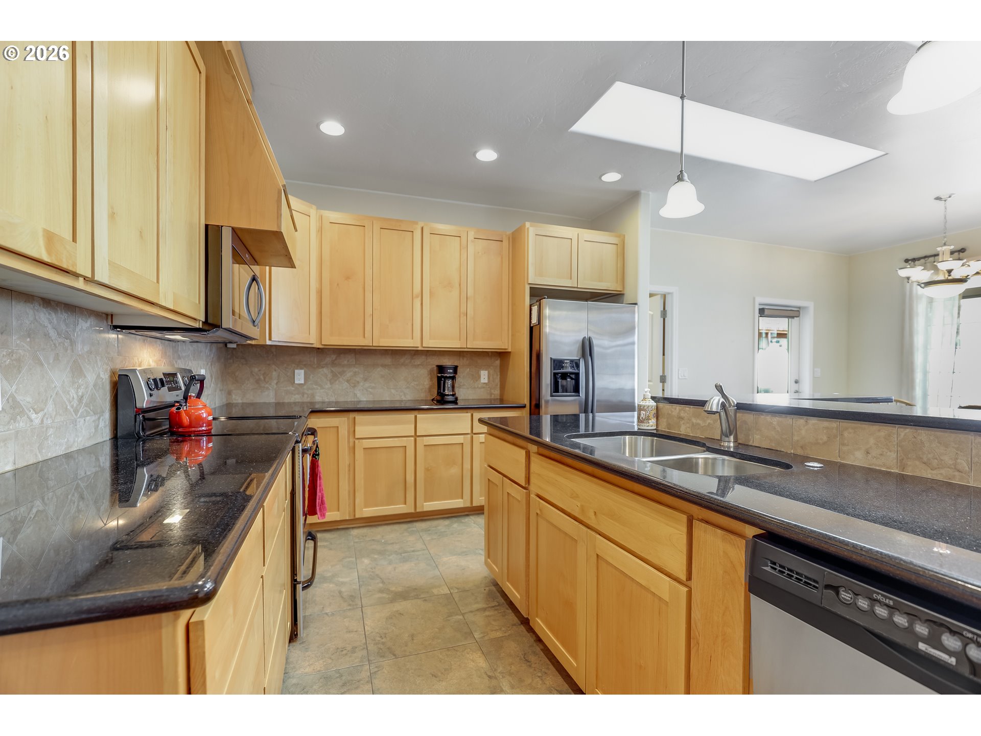 1901 Golden Way The Dalles, OR 97058 - Photo 15 of 48 a kitchen with kitchen island granite countertop a sink a counter space appliances and cabinets