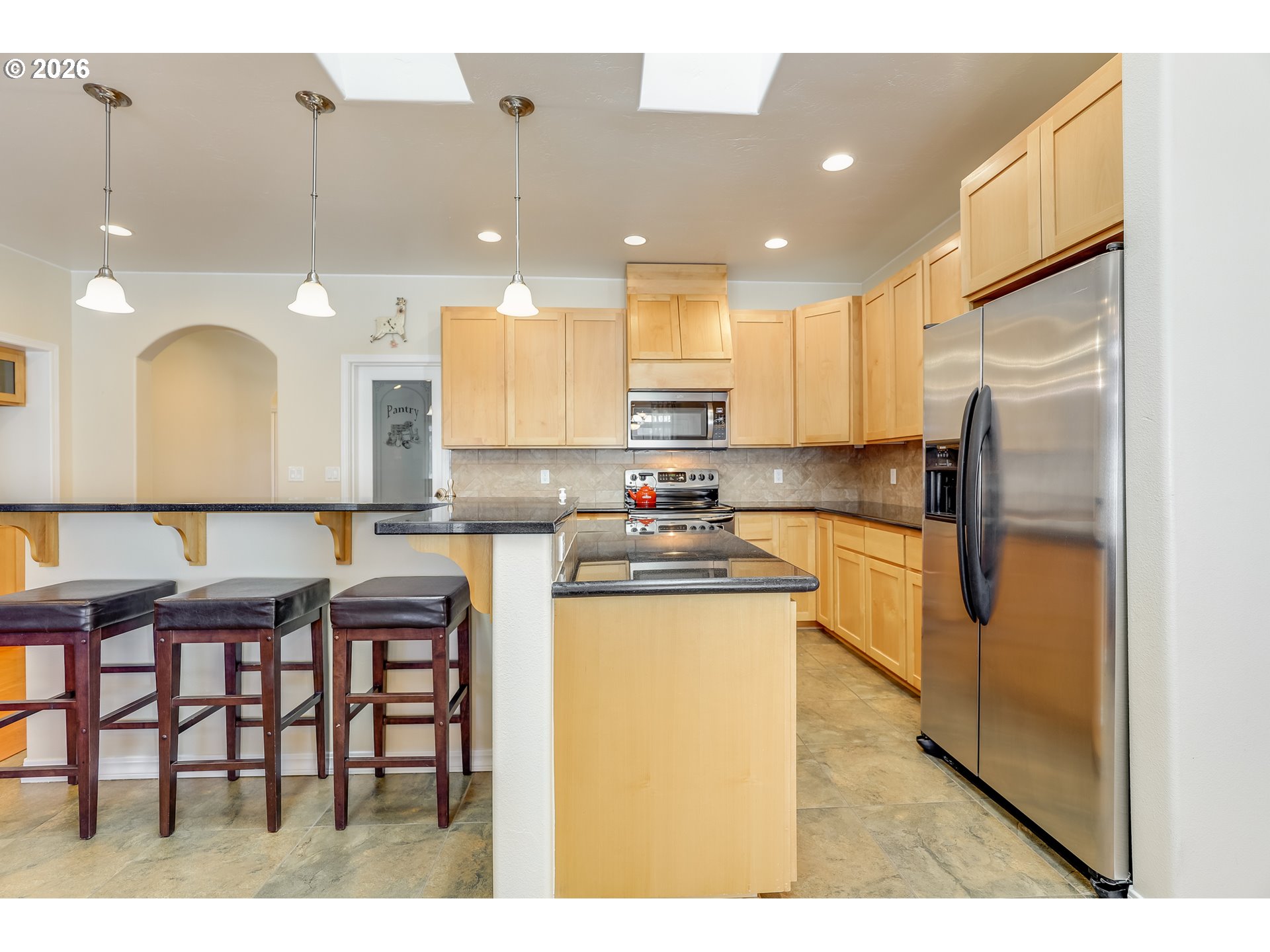 1901 Golden Way The Dalles, OR 97058 - Photo 22 of 48 a kitchen with stainless steel appliances kitchen island granite countertop a table chairs sink and cabinets