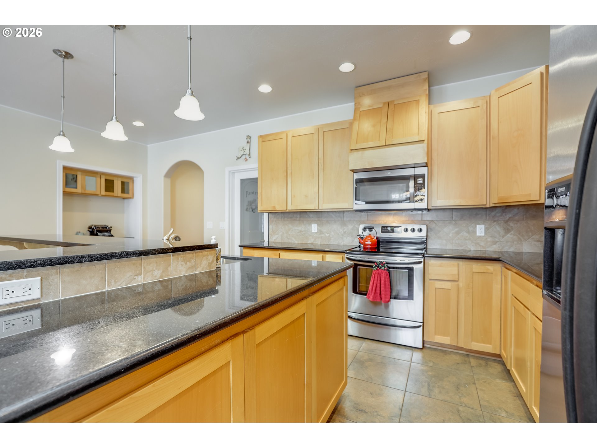 1901 Golden Way The Dalles, OR 97058 - Photo 23 of 48 a kitchen with stainless steel appliances granite countertop a sink a stove and a microwave
