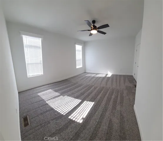 an empty room with a empty space and windows