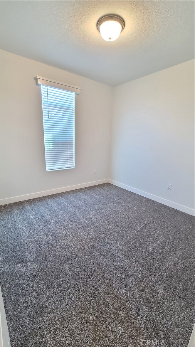2139 East 4th Street, Unit 79 Ontario, CA 91764 - Photo 13 of 18 an empty room with a empty space and windows