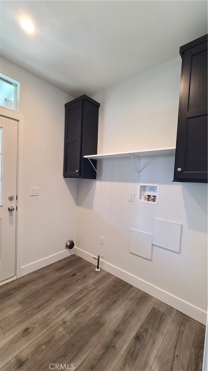 2139 East 4th Street, Unit 79 Ontario, CA 91764 - Photo 18 of 18 a view of a kitchen with wooden floor and cabinets