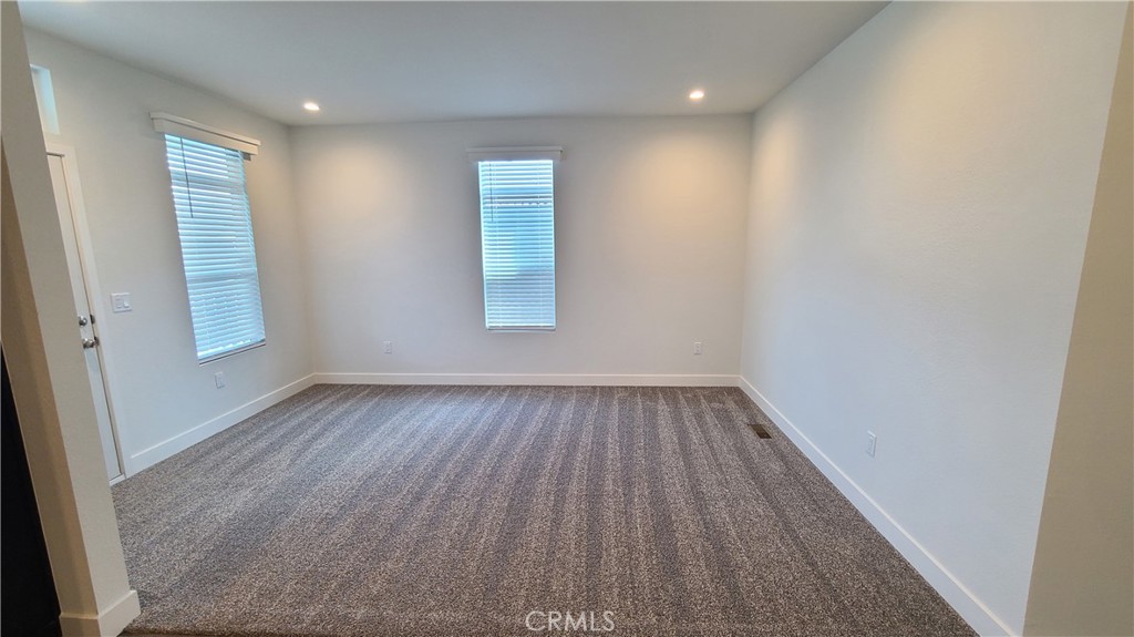 2139 East 4th Street, Unit 79 Ontario, CA 91764 - Photo 2 of 18 wooden floor in an empty room with a window