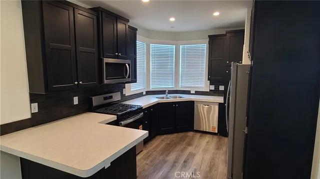 a kitchen with a refrigerator and a stove top oven