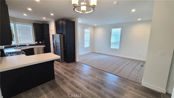 a kitchen with stainless steel appliances a refrigerator and a stove top oven