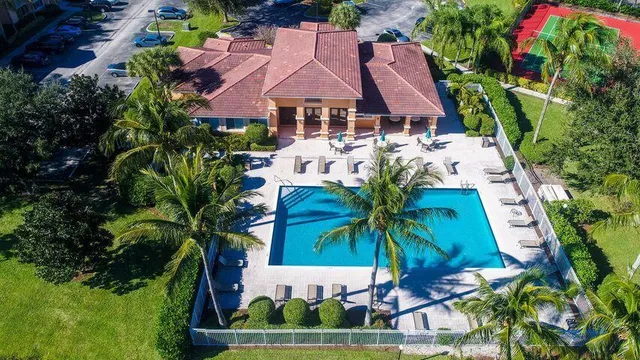 an aerial view of house with yard swimming pool and outdoor seating