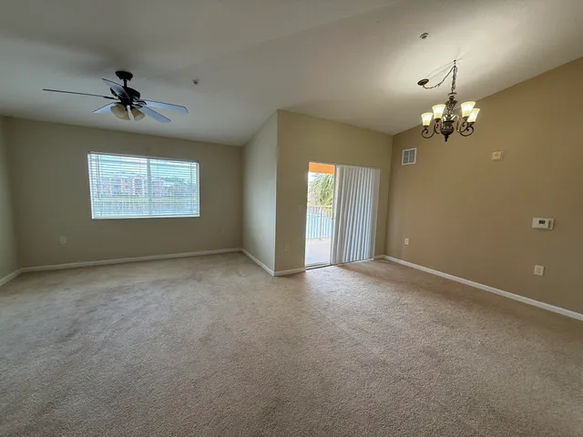 a view of a livingroom with a ceiling fan window and chandelier fan