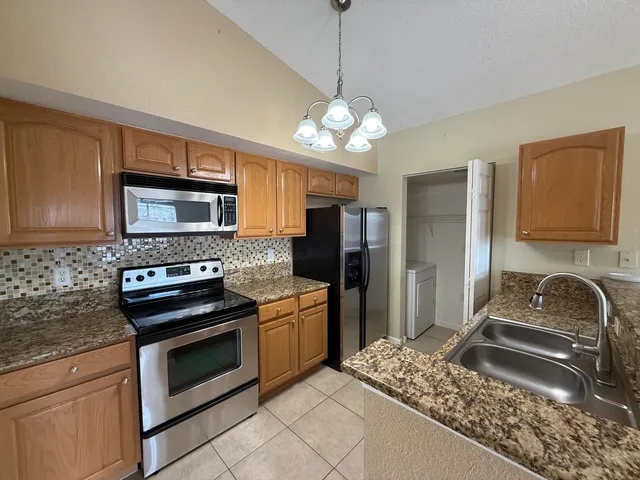 a kitchen with a refrigerator stove and microwave
