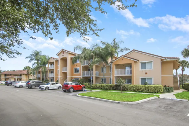 a view of road and car parked in front of house