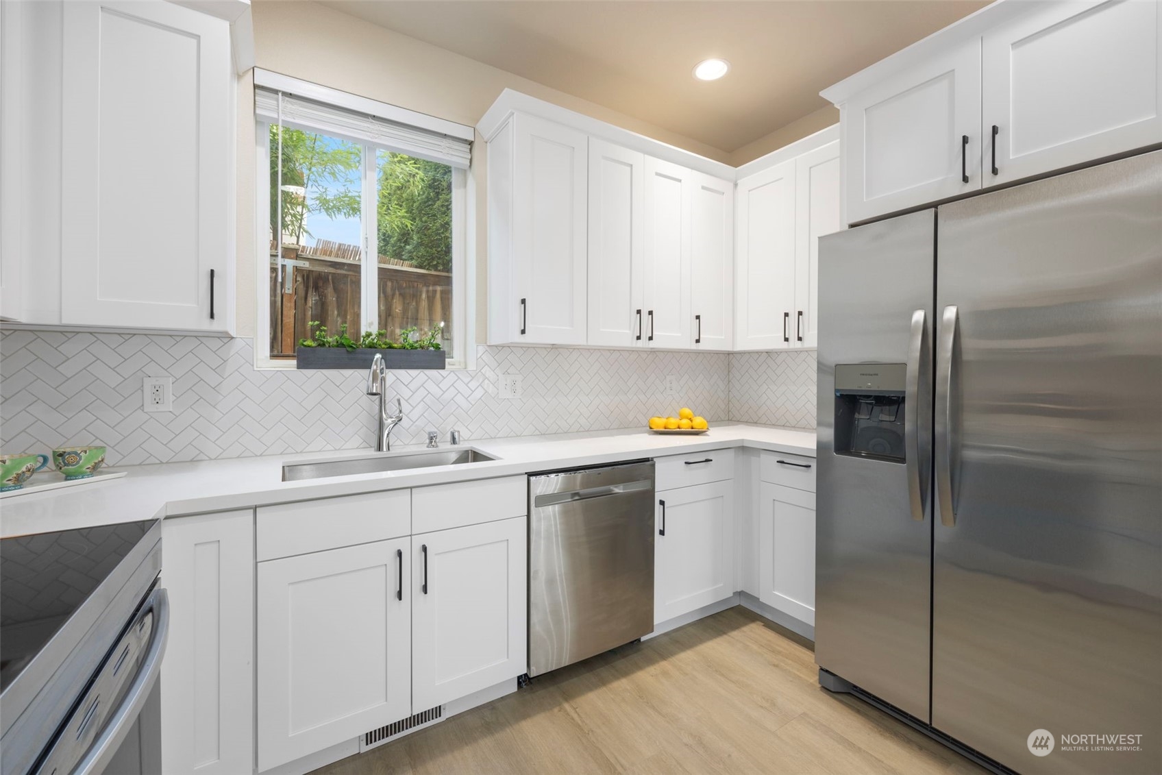 320 Graham Avenue Northeast Renton, WA 98059 - Photo 11 of 26 a kitchen with white cabinets and white appliances