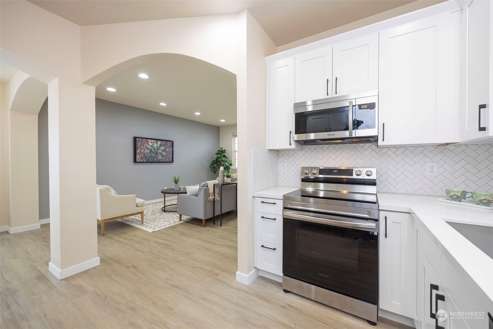 320 Graham Avenue Northeast Renton, WA 98059 - Photo 12 of 26 a kitchen with stainless steel appliances white cabinets and a stove top oven